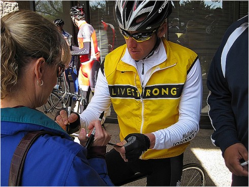 Lance Armstrong signs autographs during a Radioshack training camp in Tucson. 