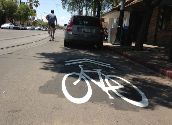 This sharrow positions cyclists into the back of a car. It's likely that parking in this area will be eliminated, but will then require cyclists to merge in and out of traffic. 