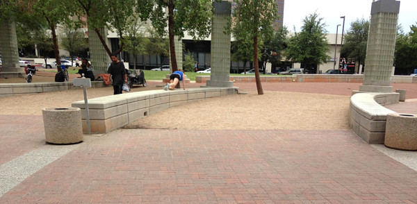 The new bike rack location will likely be in the dirt area between the benches. 