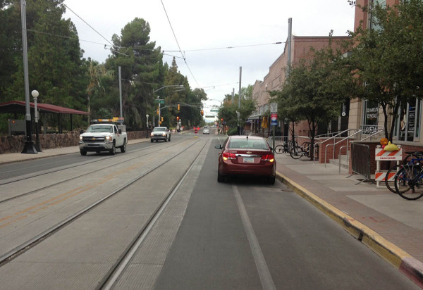 A loading zone allows cars to park in the space for bicyclists. 