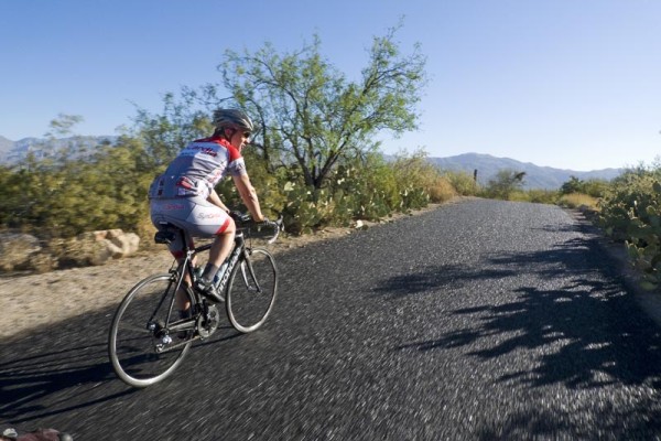A cyclist rides through Saguaro National Park East. 