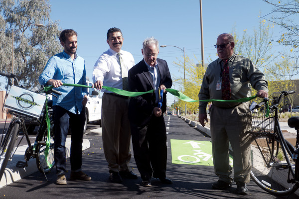 From left to right: Ian Johnson, Farhad Moghimi, Jonathan Rothschild and Daryl Cole cut the ribbon on the new bike lane in downtown Tucson. 