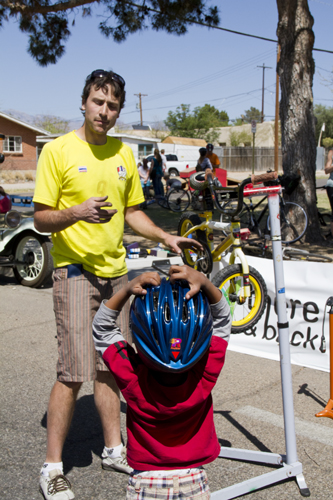 Zacharia Gladney, bottom, is told whats wrong with his bike by Steve Vihel, owner of There and Back Bikes, during Cyclovia in Tucson Ariz, on 28 March 2011.  Gladney\'s chain was loose, he said it had fallen off 20 times before stopping here.
